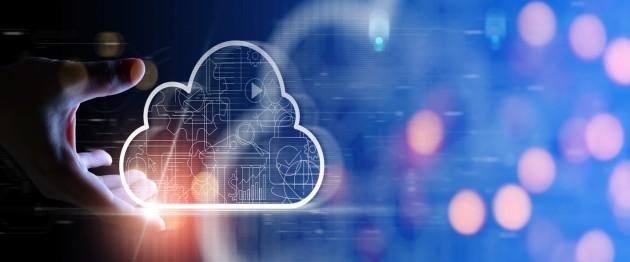 Hand reaching toward a glowing cloud icon with circuitry, symbolizing cloud computing in a blue digital background.