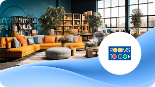 Bright furniture showroom with an orange sectional, round ottomans, bookshelves, and plants; Rooms To Go logo bottom-right.