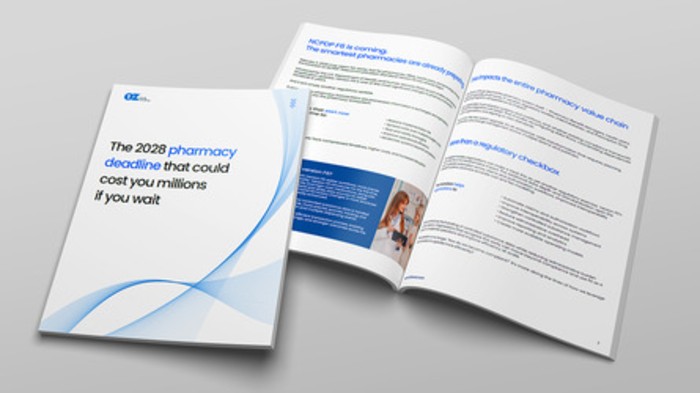 Open brochure on a light gray surface with a blue wave design; cover reads 'The 2028 pharmacy deadline that could cost you millions if you wait.' The pamphlet is partially opened to reveal internal pages with text and a photo.